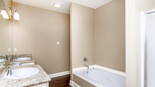 Dual vanities, Garden tub, and shower in the master bathroom