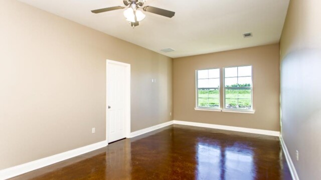 Open floor plan and stained flooring of the Oak model home