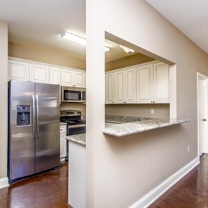 Open kitchen and beautiful stained flooring area in the Oak model home