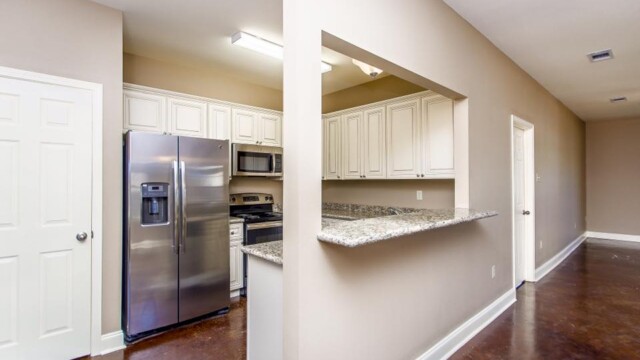 Open kitchen and beautiful stained flooring area in the Oak model home
